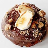 S’Mores Doughnut · Raised doughnut topped with milk chocolate glaze, graham cracker crumble, and a torched mars...