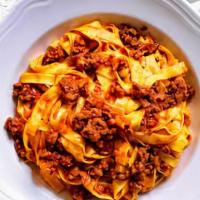 Tagliatelle Alla Bolognese · Homemade Tagliatelle with Classic three meats bolognese sauce parmigiano