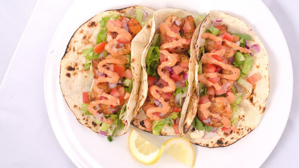 Gulf Shrimp Tacos · Three tacos filled w blackened, grilled or fried shrimp topped w cabbage, lettuce red onion and tomato with two market sauces on grilled flour tortillas.