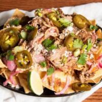 Carnitas Nachos · Beer cheese, pickled jalapeños, green onions, cherry tomato salsa, lime, pickled red onions.