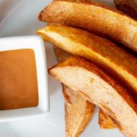 Potato Wedges · Hand-cut potato wedges with Anjoo's special sauce.