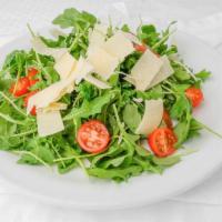 Arugula Salad · Arugula lettuce, cherry tomatoes, shaved parmesan, and lemon vinaigrette dressing.