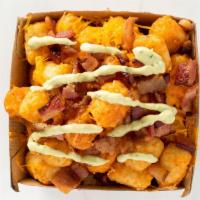 Effin Tots · Tots, melted cheese, bacon bit topped with avocado cream!
