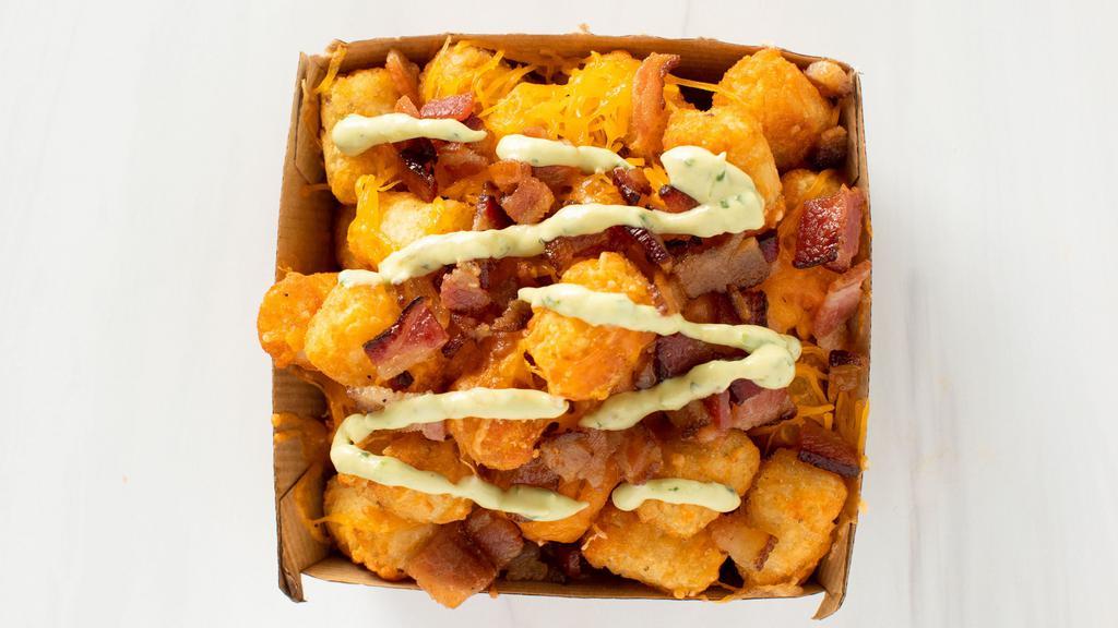 Effin Tots · Tots, melted cheese, bacon bit topped with avocado cream!
