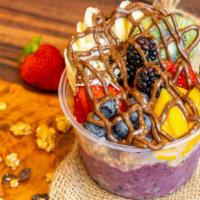 Corcovado Bowl · Topped with granola, banana, strawberries, blueberries, kiwi, mango, blackberry chia seeds, ...