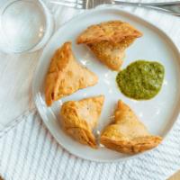 Vegetable Shingara (2 Pieces) · Triangular puffed pastry stuffed with cubed potatoes, green peas, carrots & mildly spiced he...