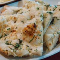 Garlic Naan · Naan bread baked in 'tandoori clay oven' topped with fresh minced garlic & cilantro.