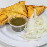 Chicken Samosas · A house specialty. Perfectly fried house-made pastry with spiced chicken. Served with a refr...