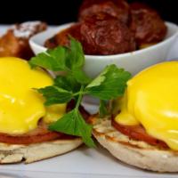 Eggs Benedict · English muffin, Canadian bacon, poached eggs, hollandaise, breakfast potato or grits.