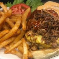 Southern Charm Burger · 8oz burger, American cheese, pulled pork, BBQ sauce & kickin' bayou mayo.