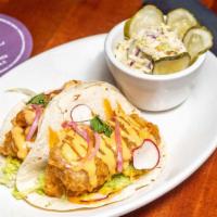 Crispy Baja Fish Tacos · Lettuce, bayou sauce, pickled onion, radish, cilantro, buttermilk-dill.