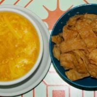 Egg Drop · Egg drop soup with tofu and eggs served with wonton chips.