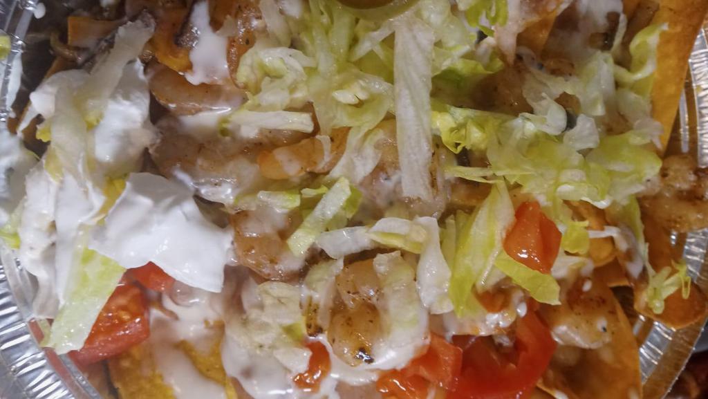 Nachos With Shrimp · Tortillas chips, beans, cheese, onions, with beans tomatoes, lettuce, sour cream, jalapeño.