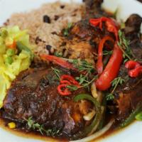 Jerk Chicken (Jc) · Served with rice and peas or white rice and cabbage.