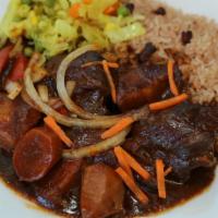 Stew Chicken (Sc) · Served with rice and peas or white rice and cabbage.