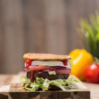Super Toston Burger · Sandwich green plantain with 1/2 lb burger beef, de mano cheese, lettuce, tomato, onion, ket...