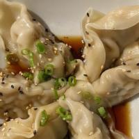 Gyoza · Six pieces. Fried or steamed beef dumplings, scallions, and sesame seeds. Served with japane...