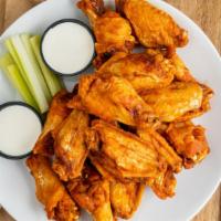 Louisiana Chicken Wings · Crispy fried wings coated in housemade wing sauce served with celery sticks and blue cheese ...