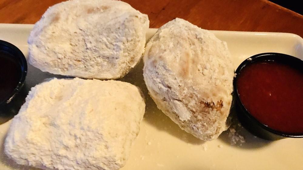 Beignets · The French market classic rectangular doughnut, flash fried and rolled in confectioner's sugar. Served with chocolate and strawberry dipping sauces.