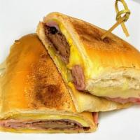 Cuban Sandwich · Homemade roasted pernil, ham, Swiss cheese, pickles, mustard on a pressed Cuban bread.