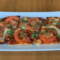 Margherita Flatbread · Crispy flatbread, Spanish tomato sauce, roma tomatoes, mozzarella cheese, oregano