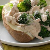 Chicken · Grilled chicken with creamy Parmesan Alfredo sauce in oven baked potato topped with green on...