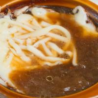 French Onion Soup · With homemade croutons and melted cheese baked to perfection.
