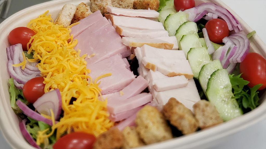 Chef Salad · Premium ham, roasted turkey, swiss and cheddar cheese, mixed greens, tomatoes, red onions, cucumbers and seasoned croutons.