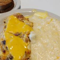 Everything But The Kitchen Sink · Bacon, sausage, ham, and cheese omelet served with your choice of grits or home fries and to...
