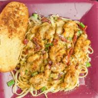 Shrimp & Pasta · Steamed shrimp served over a bed of linguini, sundried tomatoes, scallions and garlic bread.