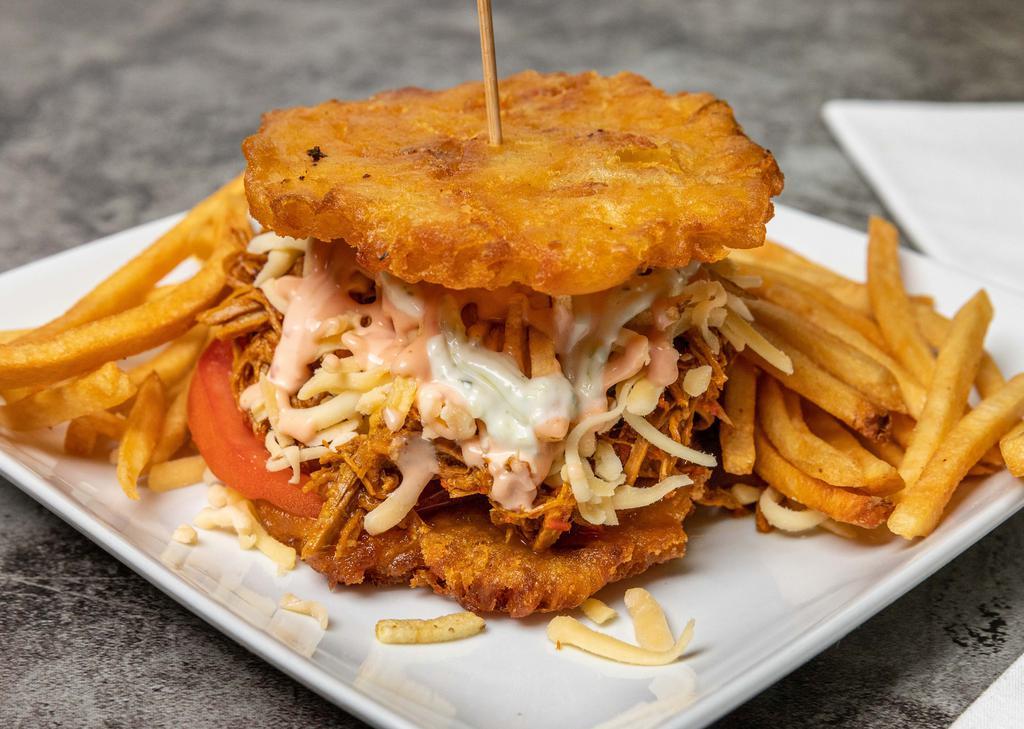 Patacon De Pollo Mechado · Shredded Chicken, lettuce, tomato, cheese, potatoes stick, sauces and fries on the side