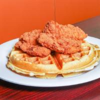 Fried Chicken & Waffles · Topped with crispy fried chicken tenders. Served with maple syrup.