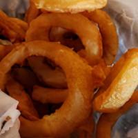 Basket Of Onion Rings · Batter dipped onion slices fried crispy and golden.