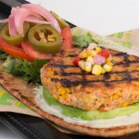 Salmon Burger · Baby Greens, Roasted Corn Relish, Pickled Jalepenos and Onions, Avocado, Horseradish-Honey M...