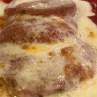 Eggplant Parmigiana · Breaded eggplant cutlets layered with tomato sauce and romano cheese. baked with mozzarella....