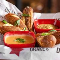 Warm Pretzels & Beer Cheese · Soft, warm pretzel bites with house mustard and beer cheese dip made from sharp cheddar chee...