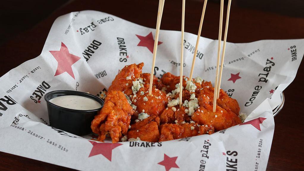 B.'S Boneless Bites -  Buffalo · Juicy, hand-breaded chicken tender bites tossed in buffalo sauce, blue cheese crumbles; ranch or blue cheese