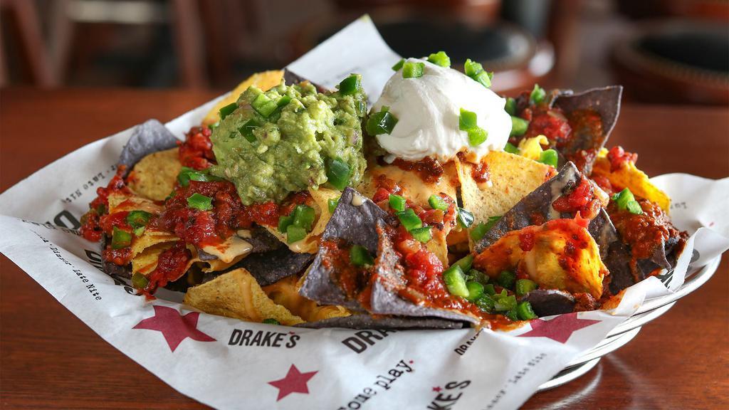 Drake'S Nachos · Fresh tortilla chips layered with beef and bean chili and warm beer cheese, topped with fire-roasted salsa, sour cream, guacamole and jalapeño.