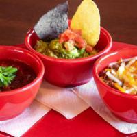 Chips 'N Dips · Fresh tortilla chips with house-made guacamole, fire-roasted salsa and refried beans.