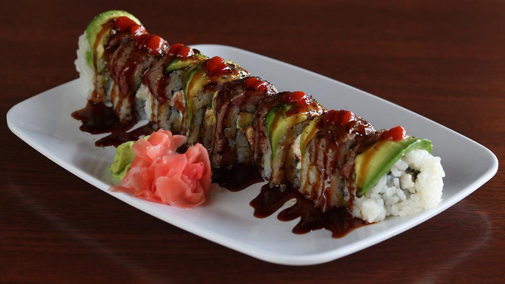 Surf & Turf Roll · Crab and cream cheese blend, spicy mayo, asparagus, seaweed; topped with avocado, seared filet mignon, sriracha and sushi sauce.