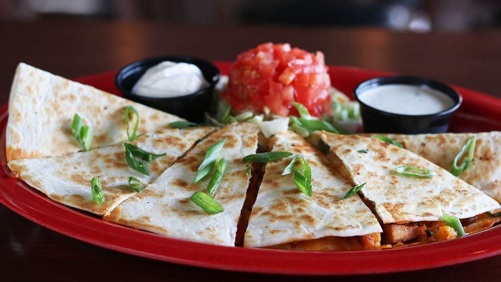 Buffalo Chicken Quesadilla · Blackened chicken in buffalo sauce stuffed in a Jumbo flour tortilla with cheese and scallions, served with sour cream and your choice of ranch or blue cheese.