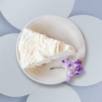 Coconut Cake · Frosted cake with a white frosting and covered in coconut flakes