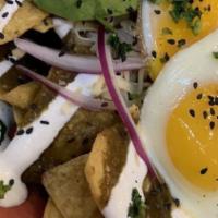 Chilaquiles Rojos O Verdes · Baked tortilla quarters mixed with our special sauces, red or green, with shredded Cotija ch...