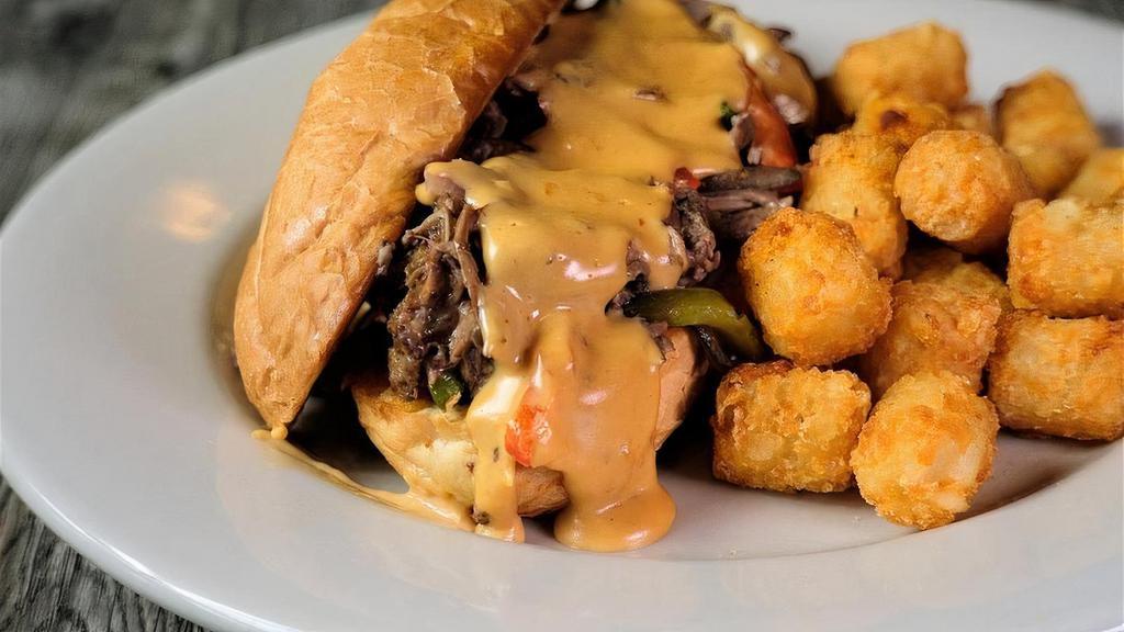 Pot Roast Cheesesteak · Tender house braised pot roast and sauteed bell pepper and red onion finished with our delicious Harp Lager cheese sauce on a toasted French roll.