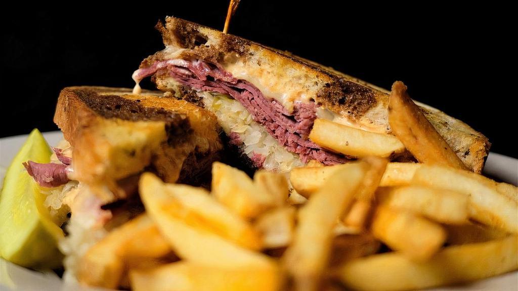 Reuben · Grilled lean corned beef with sauerkraut, melted Swiss cheese and Thousand Island dressing on toasted marble rye bread.