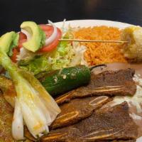 Costillas Azadas · Delicious thin slices of beef ribs. Sautéed green onion, jalapeño, and nopal (cactus). Serve...