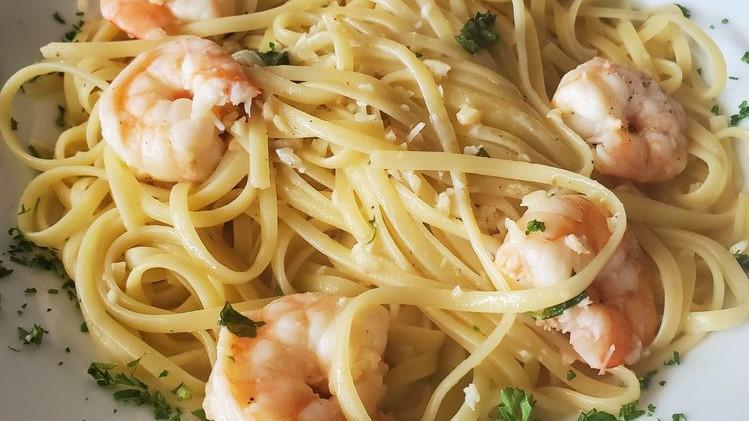 Shrimp Scampi · Sautéed shrimp in a garlic, wine, lemon butter sauce served with pasta.