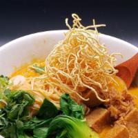 Kao Soi Curry Noodle Soup · Steamed & fried egg noodle in yellow curry soup, bok choy, fried shallot, scallion, cilantro.