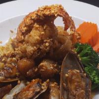 Garlic Seafood · Lightly battered then sauteed in garlic, black pepper with shrimp, half lobster tail, scallo...