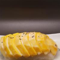 Mango Sticky Rice · Thai dessert sticky rice cooked in coconut cream and syrup served with mango top with sesame...
